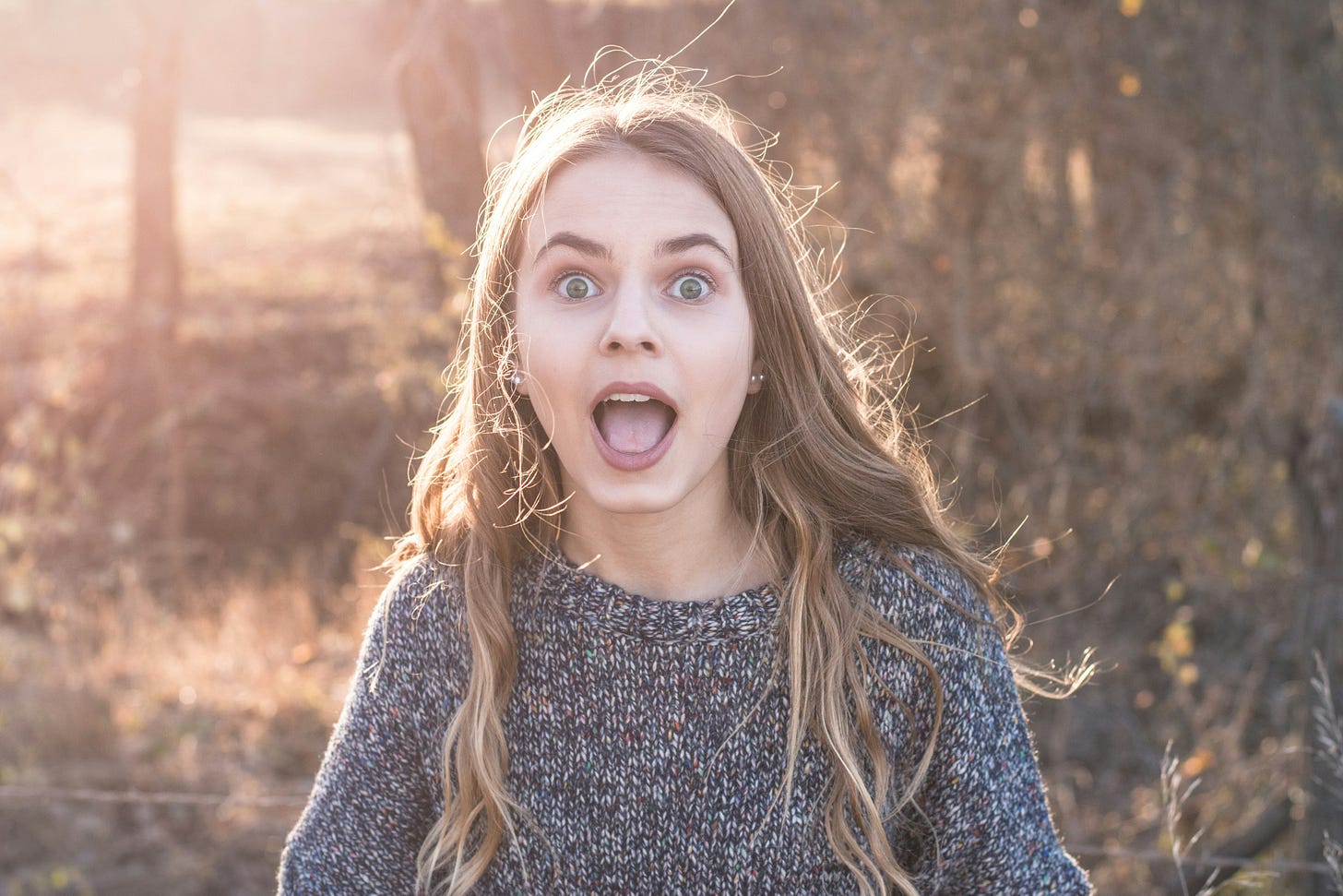 pretty young woman standing in golden hour light pretty young woman standing in golden hour light