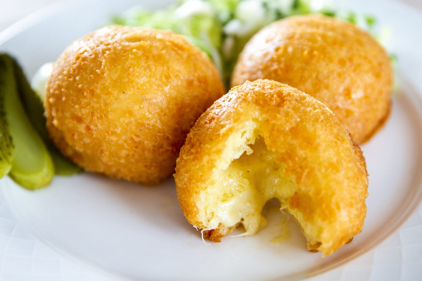 Malakoff, a traditional Swiss deep-fried cheese balls or fritters, particularly popular in the Lake Geneva region. Photo by Sigfredo Haro