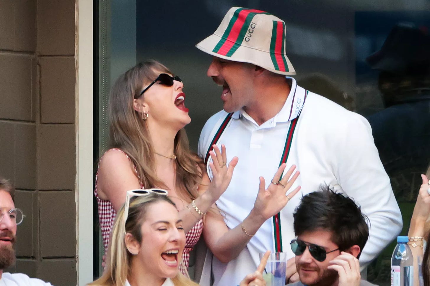 Taylor Swift sings with Travis Kelce during the men's final on day fourteen of the 2024 US Open Tennis Championships at the USTA Billie Jean King Tennis Center on September 8, 2024 in Flushing Meadows, Queens, New York City. 