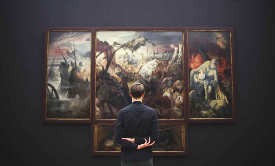 man looking at a painting