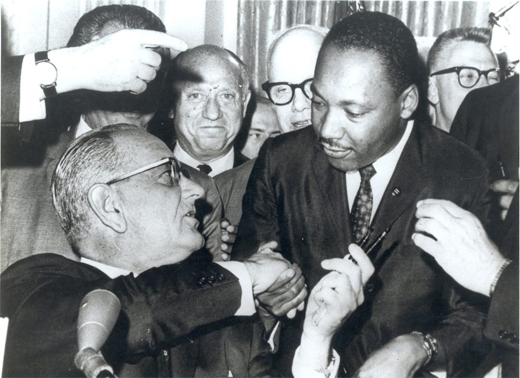 LBJ and MLK shake hands after signing Title VII