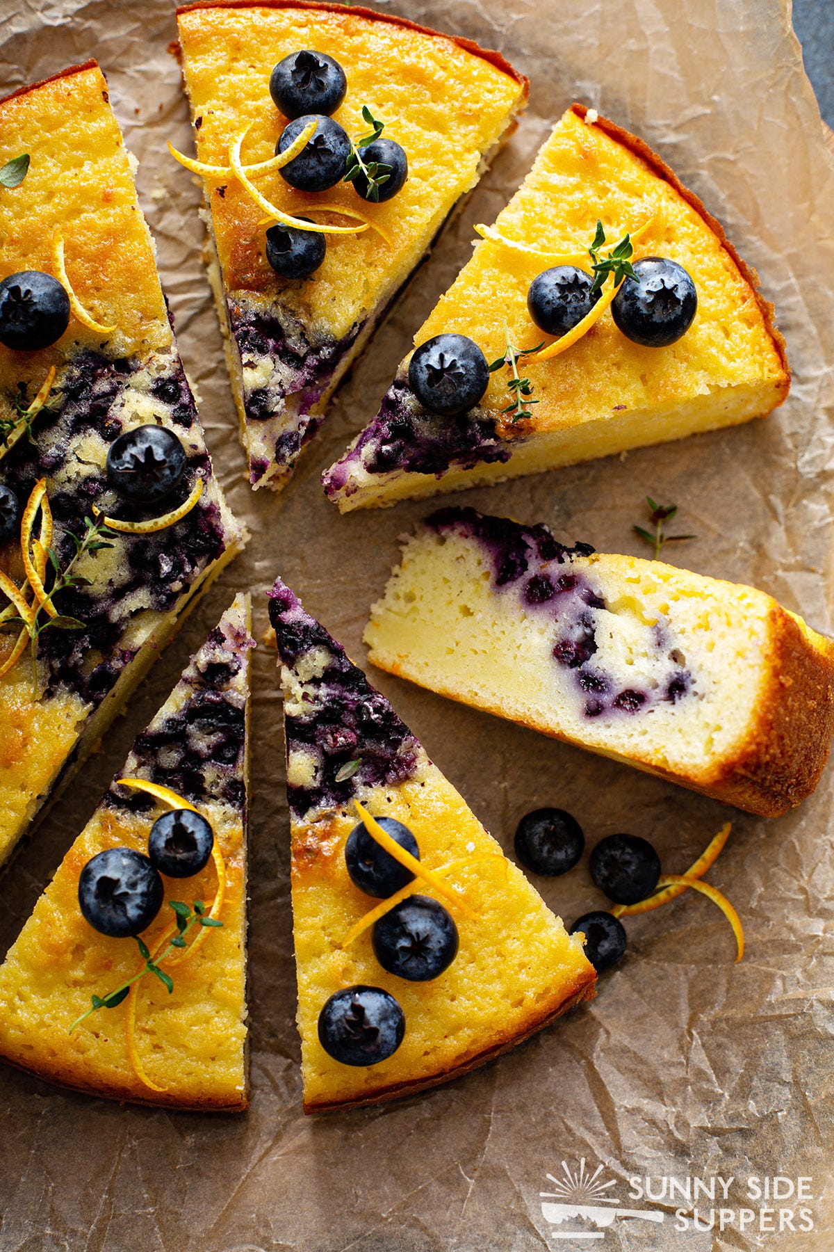 Sliced blueberry coffee cake on parchment paper.