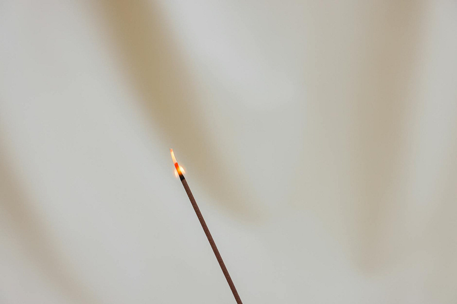 https://www.pexels.com/photo/lighted-incense-stick-on-white-background-7303274/