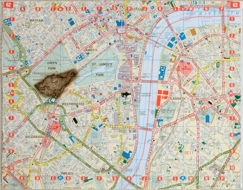 A highly detailed map of central London with a scorch mark over buckingham palace