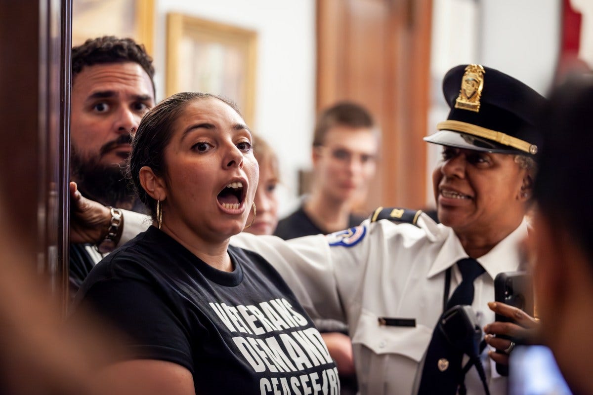 Capitol Police Captain Rani Brooks warns Brittany Ramos DeBarros and other U.S. military veterans occuping Sen. Kirsten Gillibrand's (D-NY) office that they risk arrest if they do not stop blocking the door as they demand a ceasefire in Gaza. They refuse to leave until they speak to Gillibrand - known for her support of veterans - in person or by phone. (Photo by Allison Bailey/NurPhoto via AP)