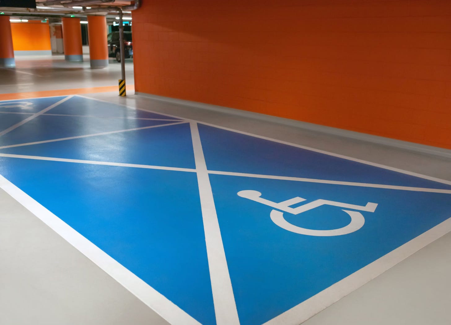 Wheelchair symbol painted on an indoor parking space