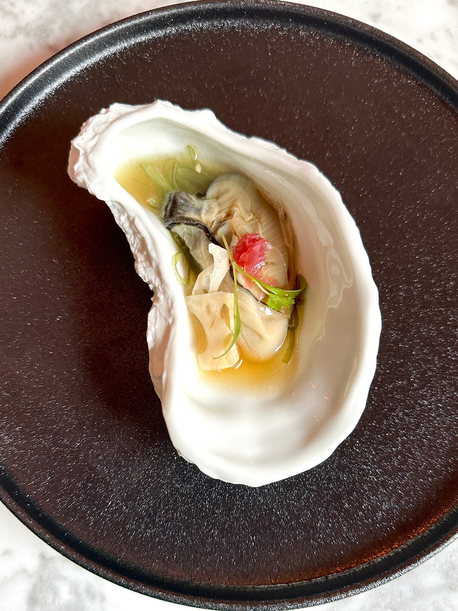 Oyster with koji, pickled lotus root and wakame at Floritz