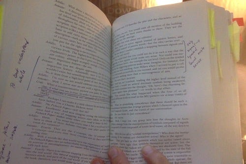 photo of GEB opened to a 2 - page spread covered with handwritten notes in margins, etc. Post-its are visible on many other pages in the book.