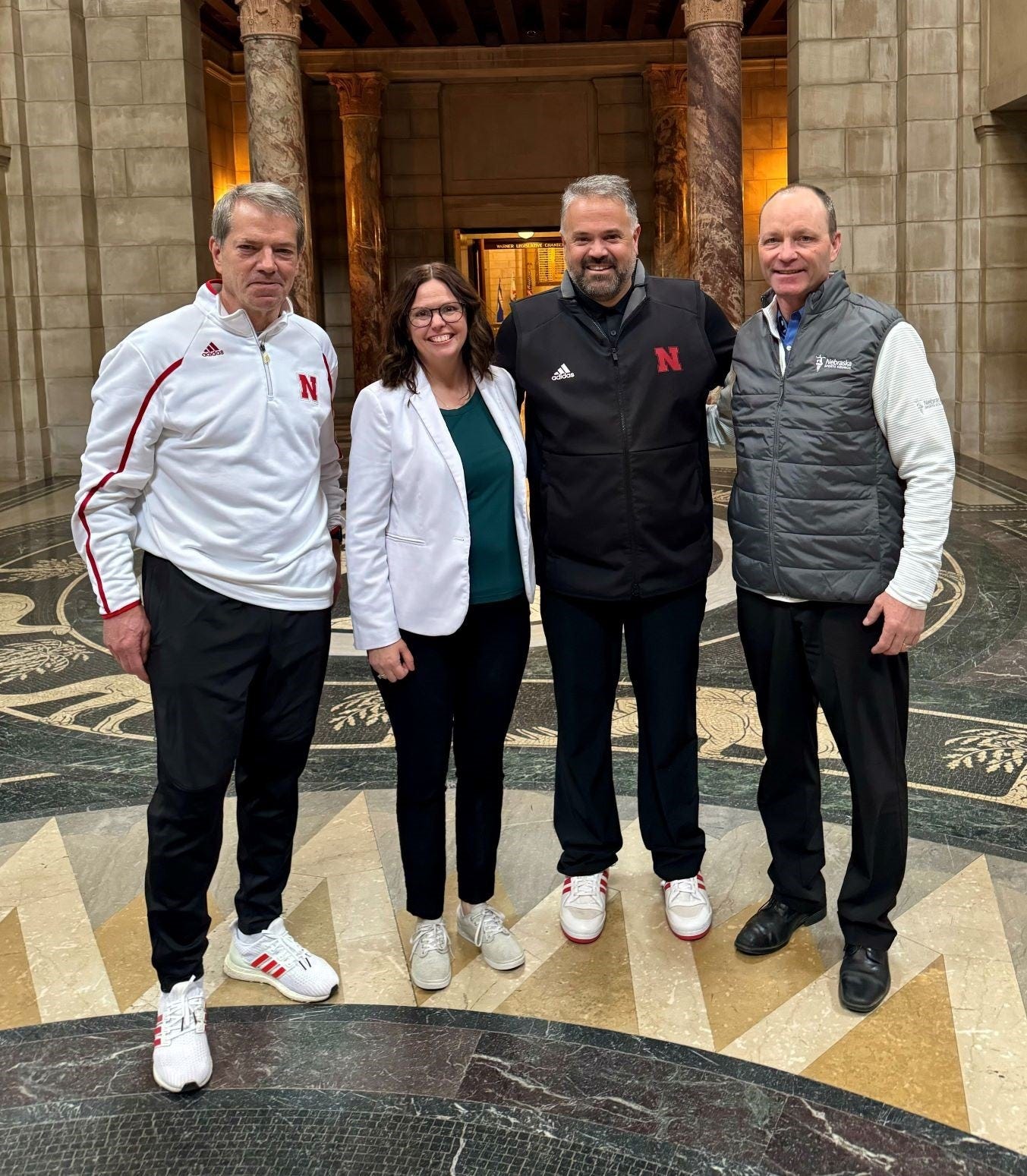 L to R: Gov. Jim Pillen, Charity Menefee, Coach Matt Rhule, and Dave Mlnarik