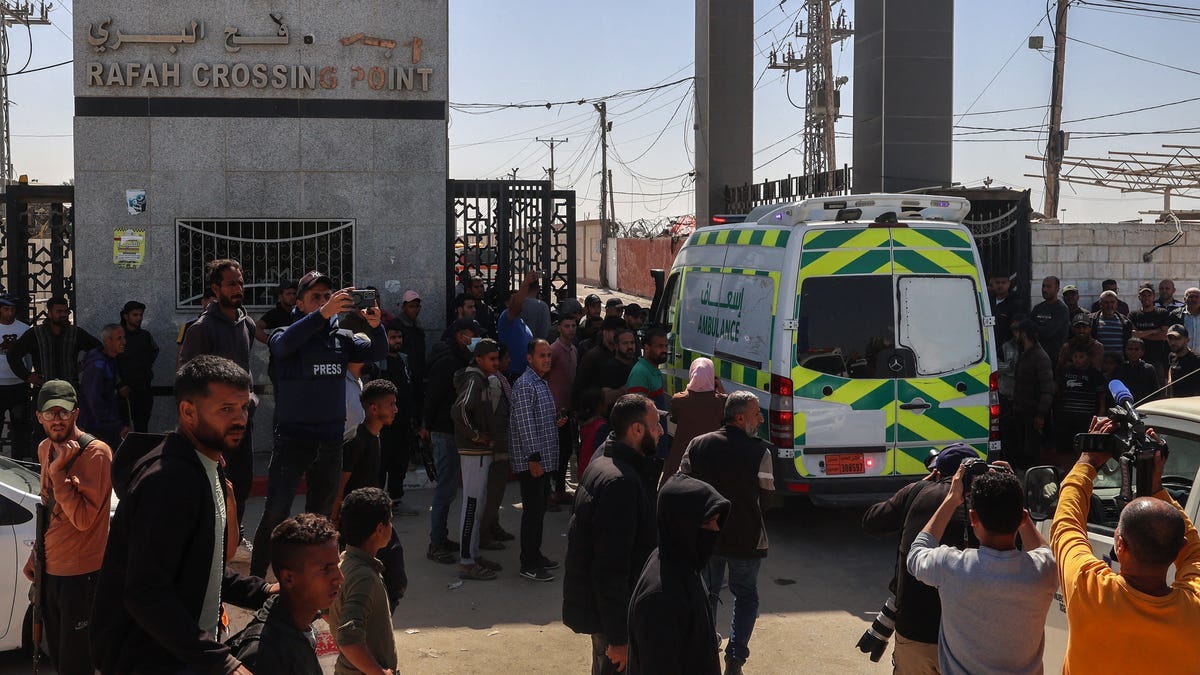 One of the ambulances carrying the bodies of staff members of the US-based aid group World Central Kitchen, arrive at the Rafah crossing with Egypt in the southern Gaza Strip on April 3, 2024.
