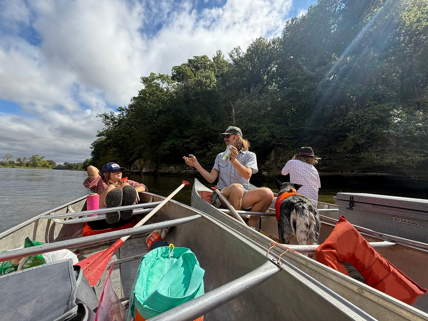 Casey, Hayden, and Bennett relax in canoes on the Fox River.