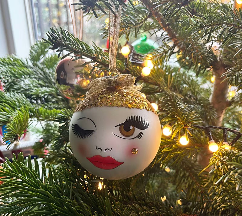 A bauble on my Christmas tree which is a face with a winking eye and a glittery top