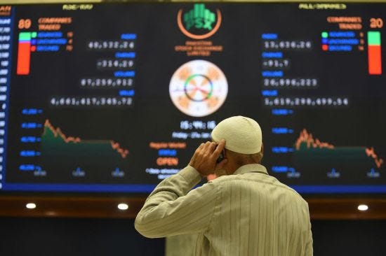 A broker watches latest share prices at the Pakistan Stock Exchange.