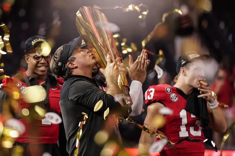 Georgia head coach Kirby Smart kisses the championship trophy after the national championship NCAA College Football Playoff game against TCU, Monday, Jan. 9, 2023, in Inglewood, Calif. Georgia won 65-7. (AP Photo/Ashley Landis)