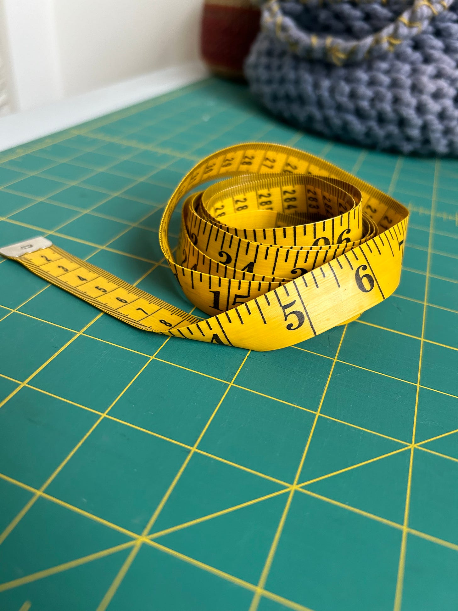 Yellow measuring tape on a green background