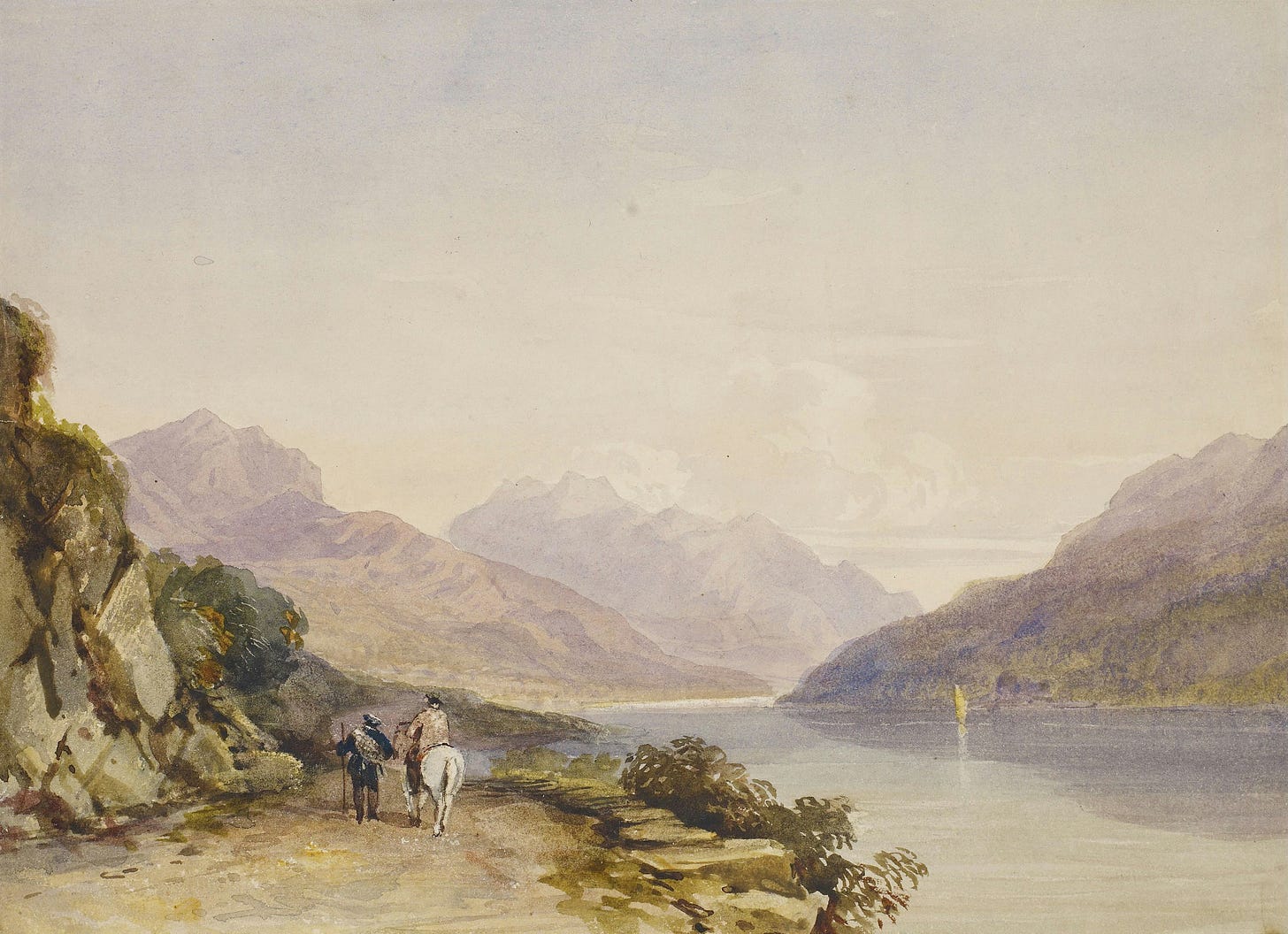 people travelling alongside a lake in Scotland