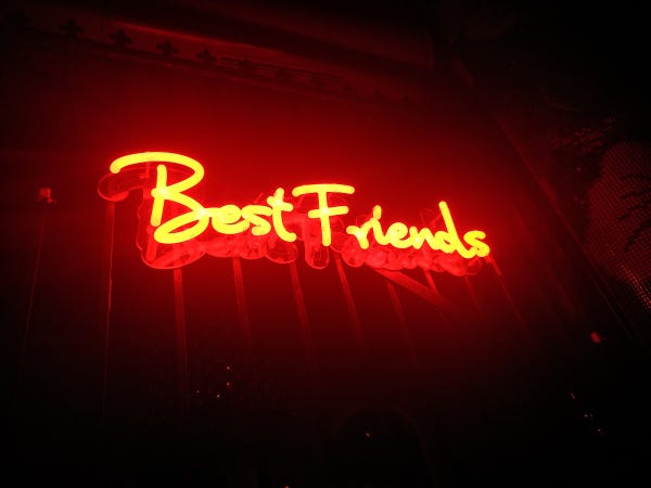 Red neon light that spells out Best Friends