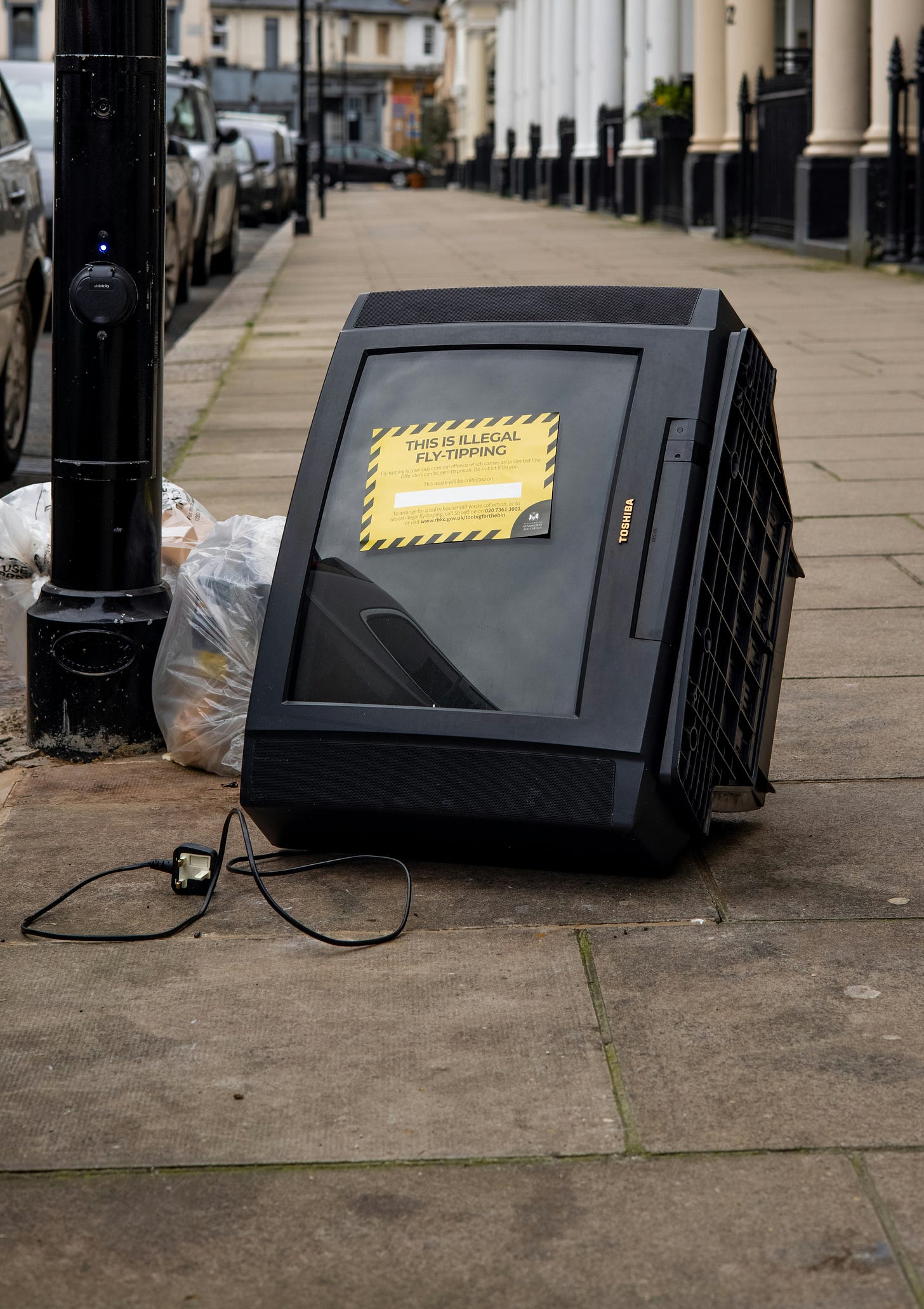 Abandoned Toshiba CRT television on a city sidewalk. Abandoned Toshiba CRT television on a city sidewalk.