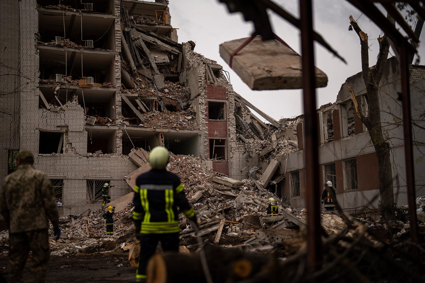 Firefighters work on a building that was partially destroyed after a Russian bombardment in Chernihiv, Ukraine.