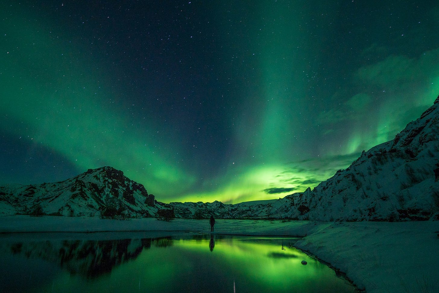 An Iceland landscape with Northern Lights in the sky reflected in a lake An Iceland landscape with Northern Lights in the sky reflected in a lake