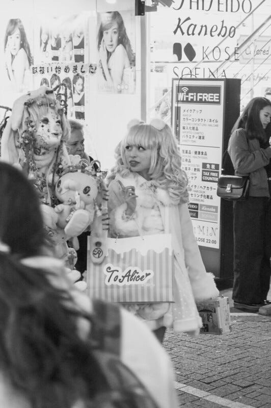 Monochrome photo of two cosplaying young women on a street in Harajuku, Tokyo