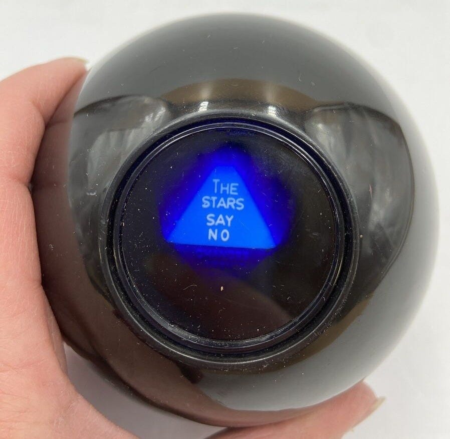 A Magic 8 Ball with an answer up that reads "the stars say no"