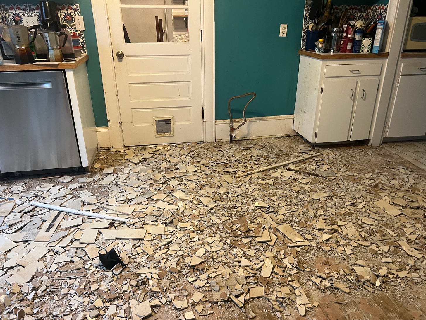 Alison's Kitchen with rubble on the floor during demolition phase.