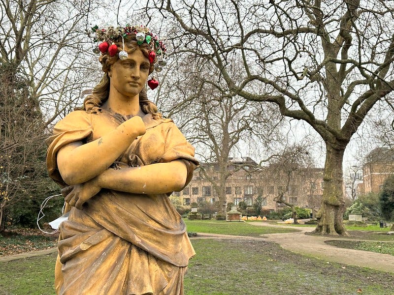 the goddess Euterpe in terra-cotta with a selection of festive baubles on her head. She looks decidedly unimpressed