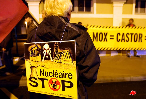Anti nuclear activists protest against a train carrying 11 containers for the transportation and storage of nuclear waste, called CASTORs, in Valognes' rail station, northwestern France, Tuesday, Nov. 22, 2011. CASTOR shipments will expect to leave from Valognes to Gorleben (Germany) on Wednesday Nov. 23, 2011. (AP Photo/David Vincent)