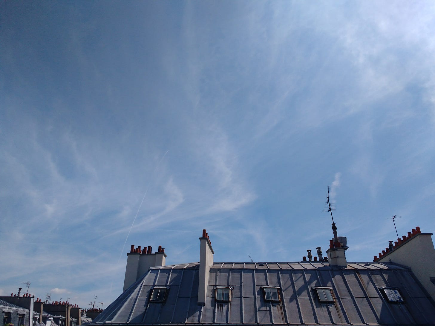 blue skies above zinc roof in Paris, France