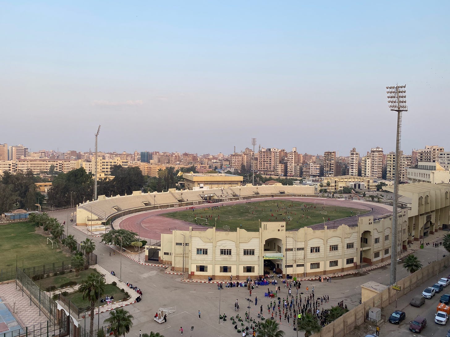 A view of the city of Mansoura with high rise buildings and a stadium