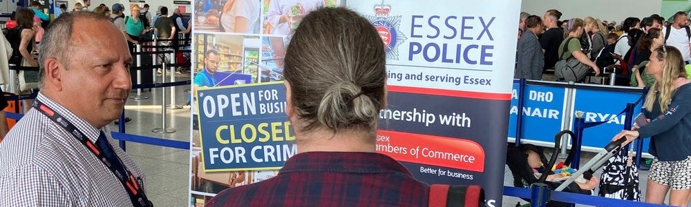 Business Crime Team talking to people at Lakeside with promotional banners in the background