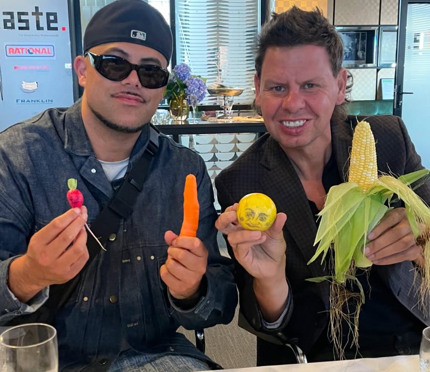 Melodownz and Paddy Gower smiling and holding vegetables