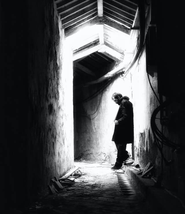 Contemplative man in an alleyway