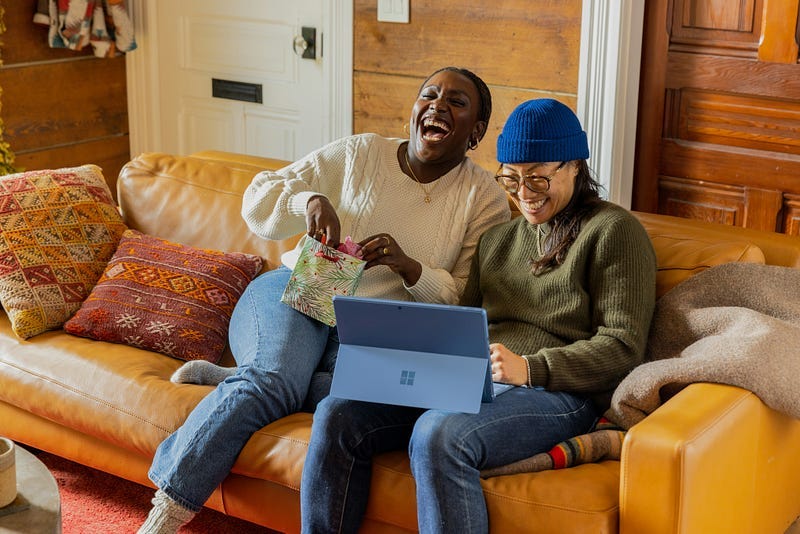 two happy people sitting on a sofa
