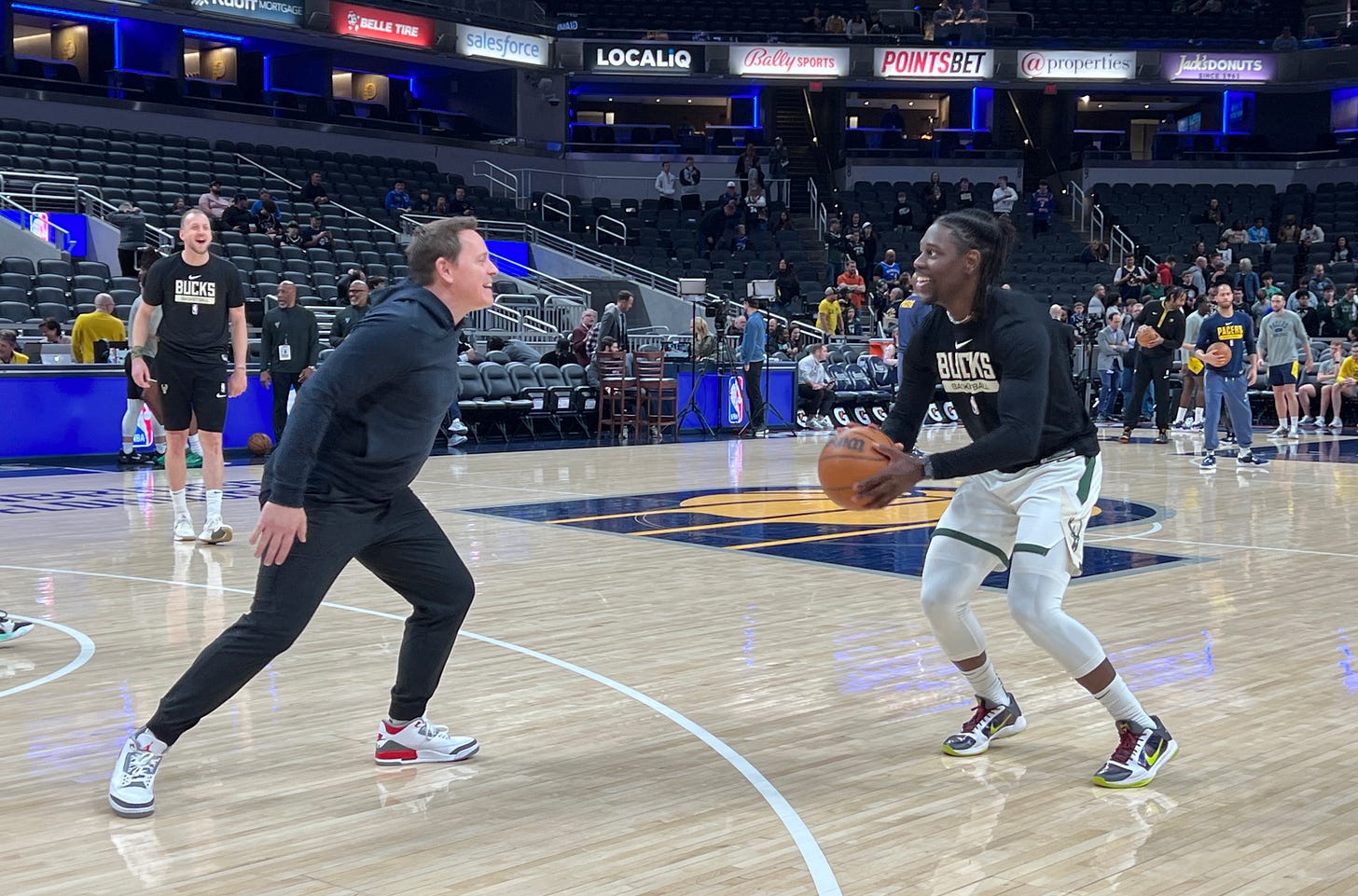 Jrue Holiday going through his warmup against Bucks assistant coach Chad Forcier.