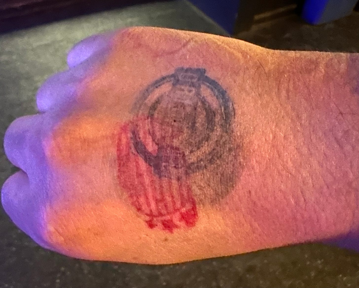 The back of my right hand featuring three venue hand stamps from Liberation Weekend. One black, one blue, one red.