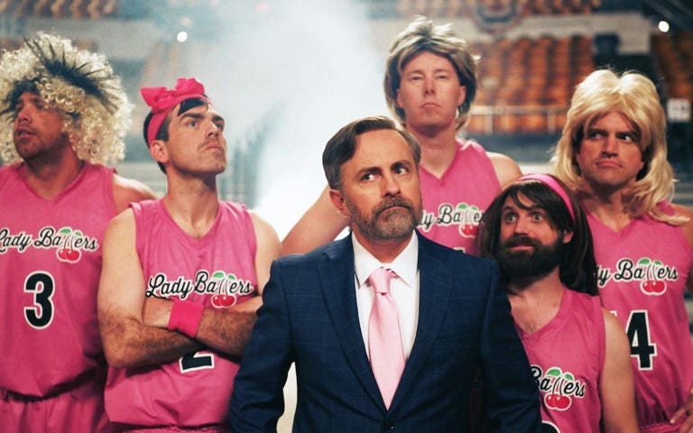 The movie was written and directed by Jeremy Boreing (centre), who plays the coach of the fake transgender team