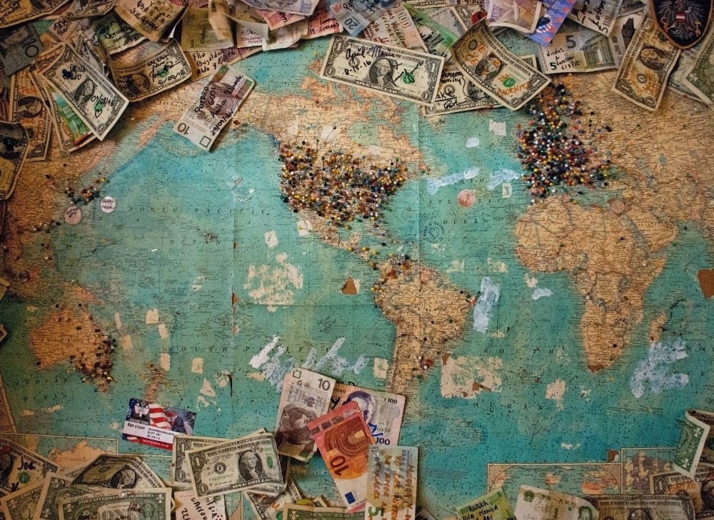 Map of the world with different country's money spread around the edges
