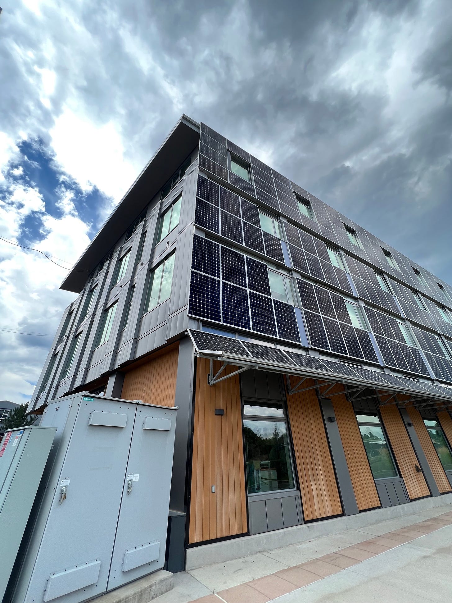 The RMI Boulder office building. The east wall is almost entirely covered by vertical solar panels, interspersed with windows.
