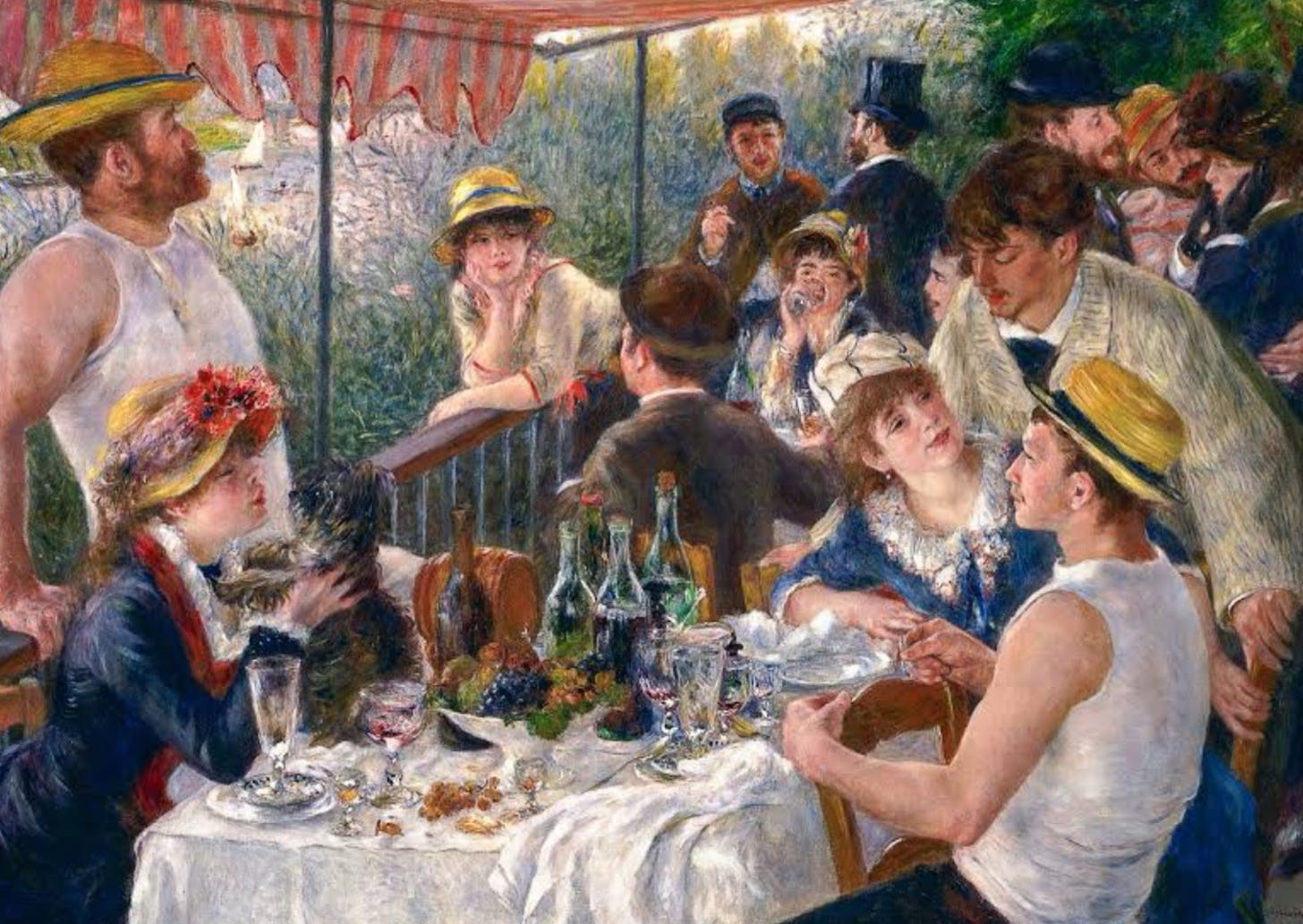 a happy scene of young people having a good time in summer around a lunch table