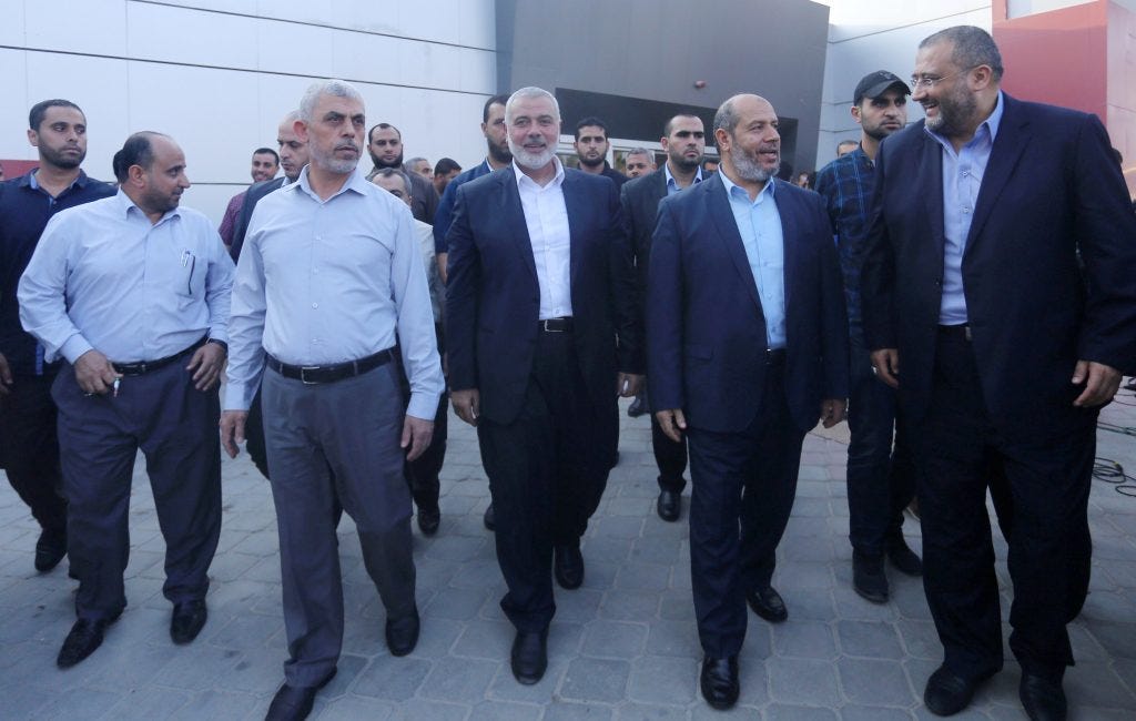 Yahya Sinwar (left), Ismail Haniyeh (middle), and Khalil al-Hayya (right) arrive at the Palestinian side of the Rafah border crossing, September 19, 2017, ahead of receiving a Palestinian Unity Government. (Photo: Yasser Qudih/APA Images)