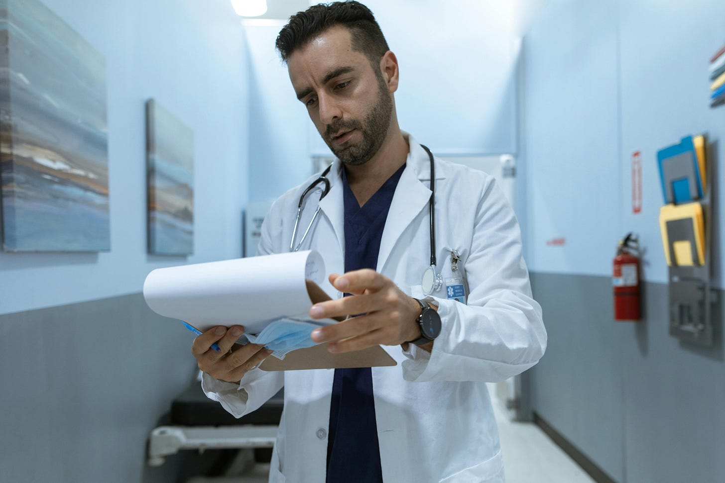 Photo of doctor reading patient chart