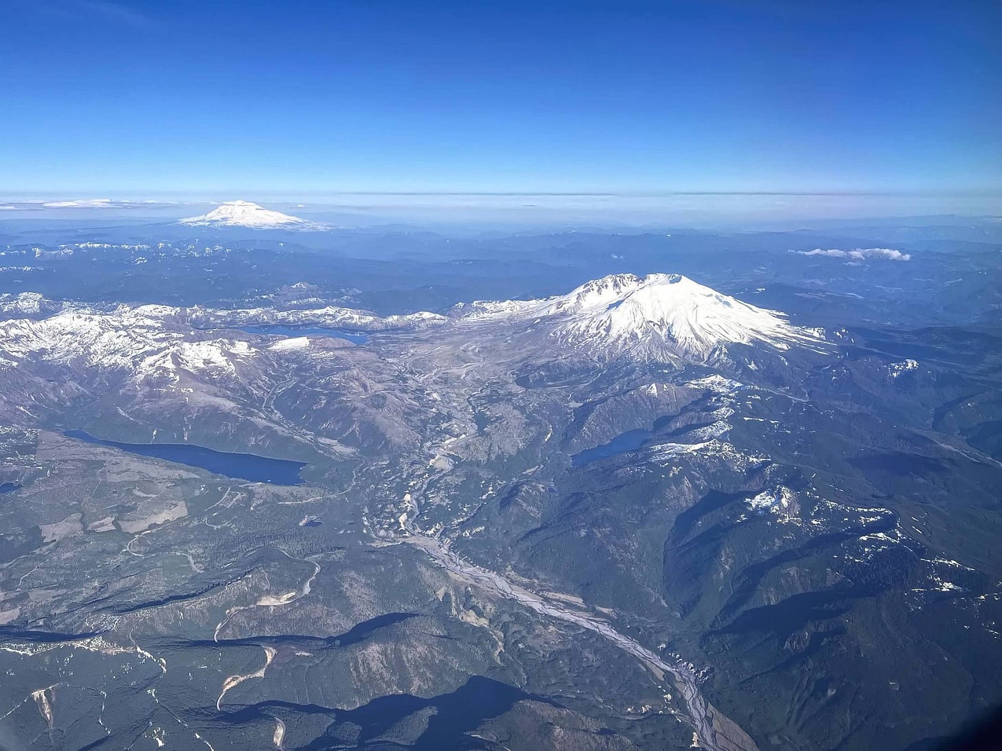 aerial view of Mount Saint Helens with alpine lakes and another mountain in the background