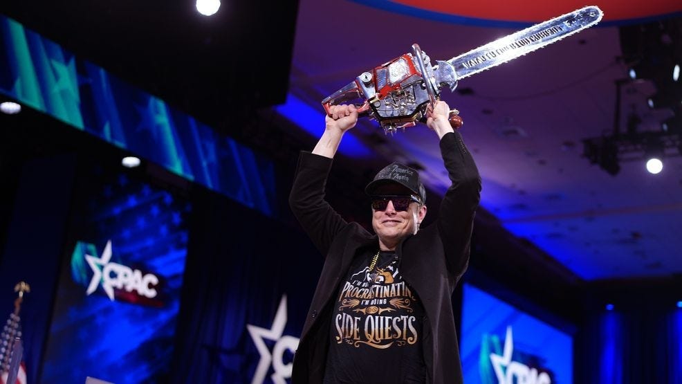 Elon Musk leaves the stage holding a chainsaw after speaking at the Conservative Political Action Conference (CPAC) at the Gaylord National Resort Hotel And Convention Center on February 20, 2025, in Oxon Hill, Maryland. (Photo by Andrew Harnik/Getty Images)