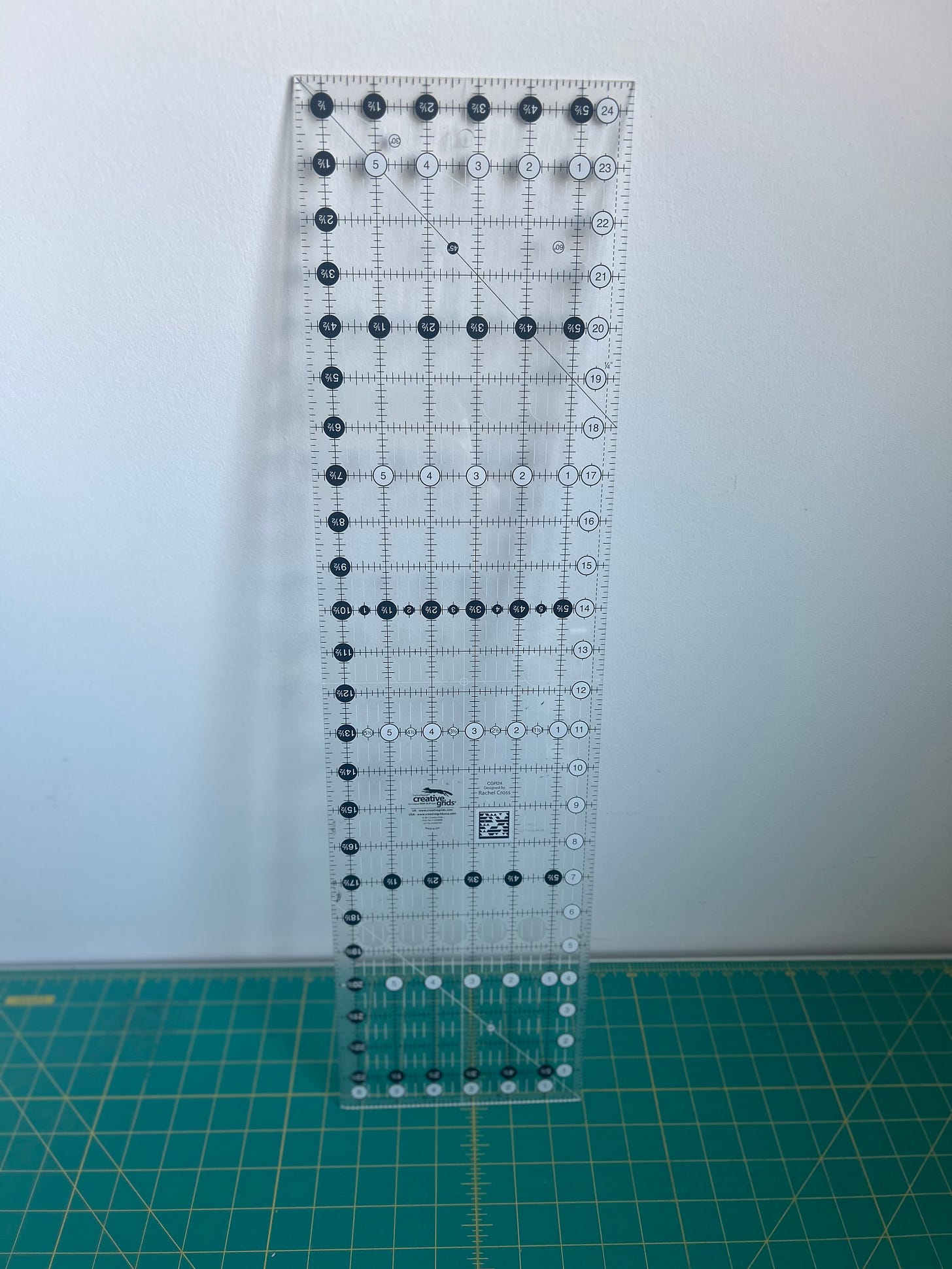 Large clear ruler leaning against a white wall