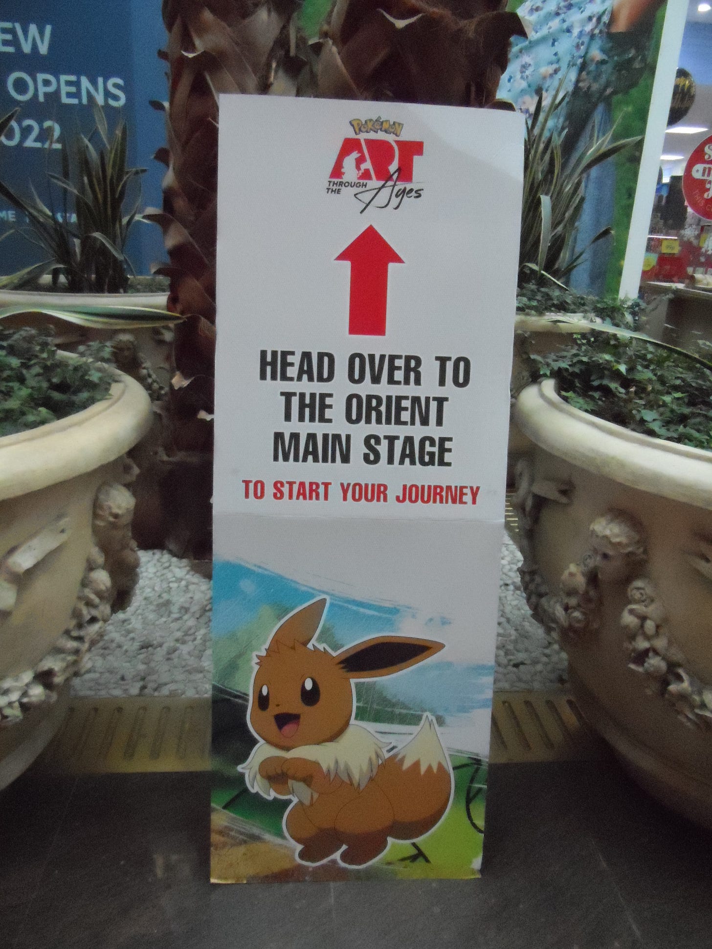 A sign featuring Eevee pointing in the direction of the stage