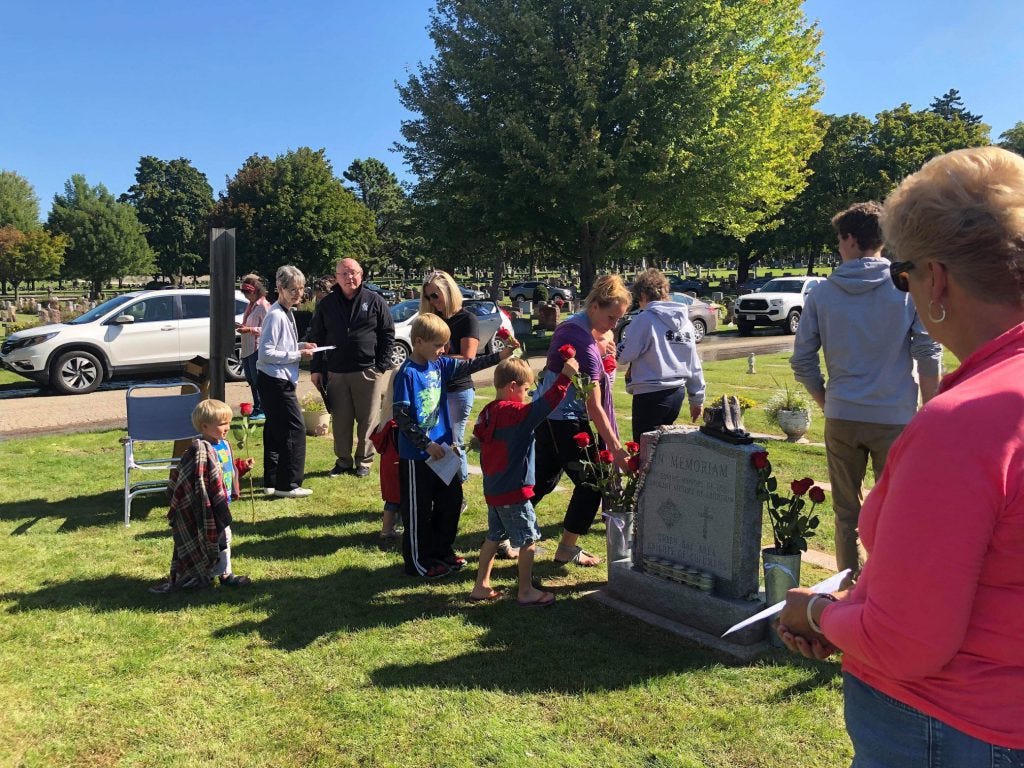 people honoring aborted children at a grave headstone