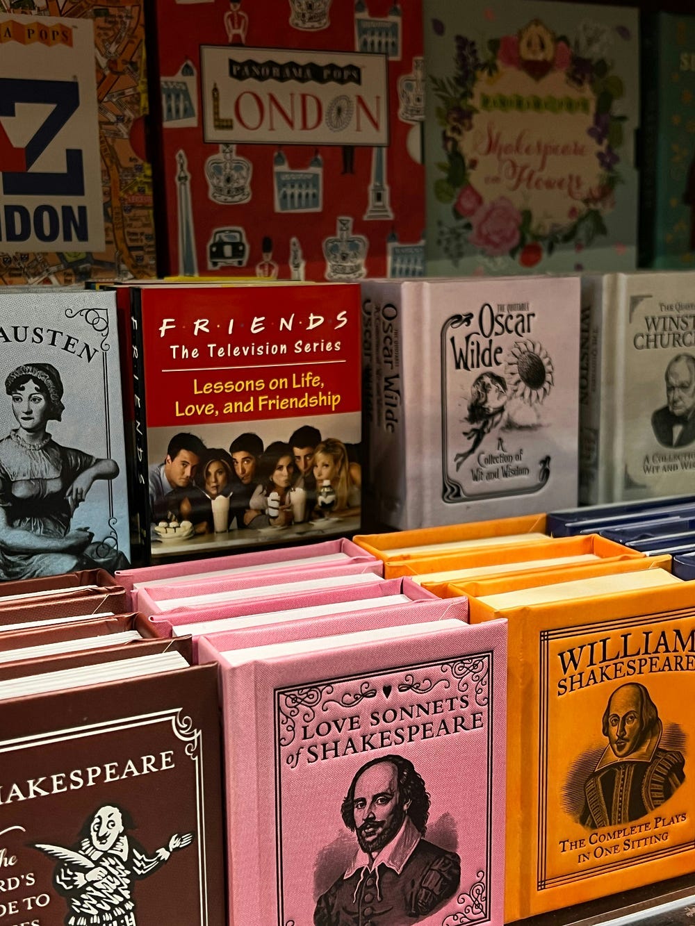 A display of books by authors.