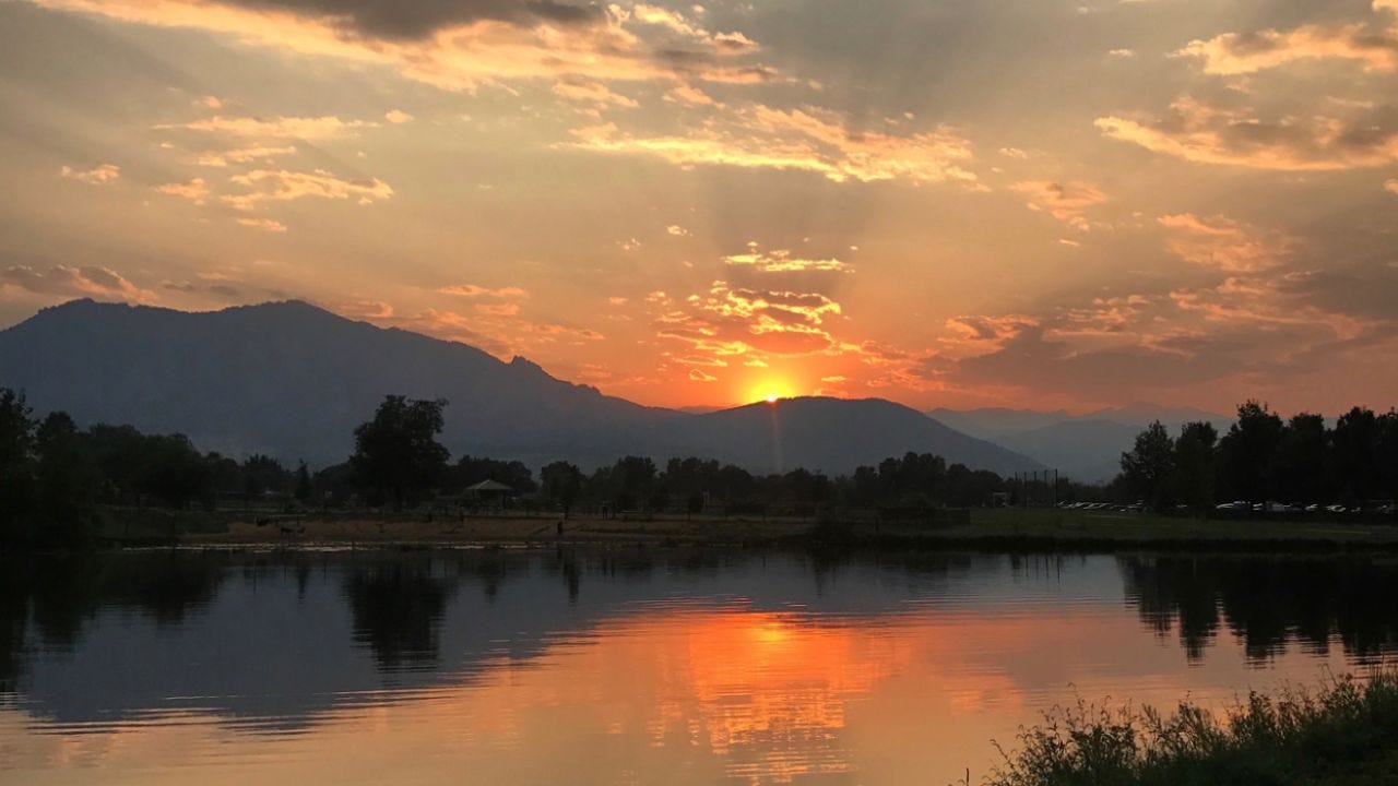 Sunrise or sunset - lake with sun and clouds